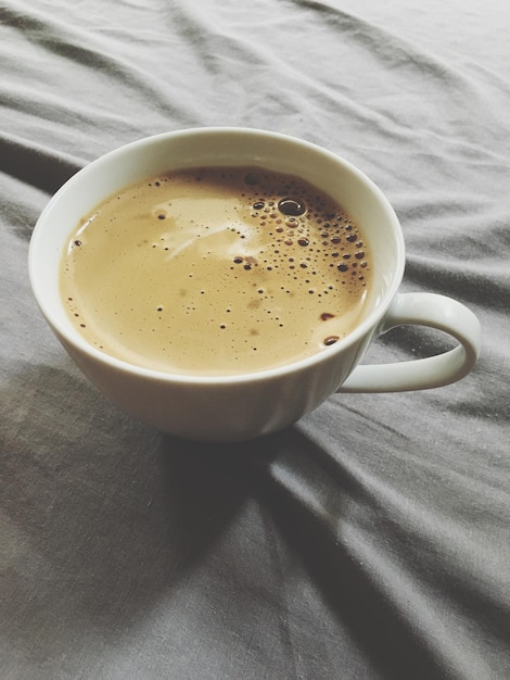 Coffee cup on bed