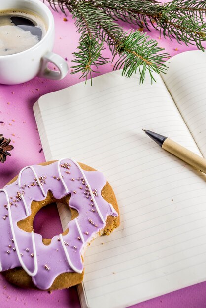 Coffee cup and biscuits donut with sugar coating and notepad