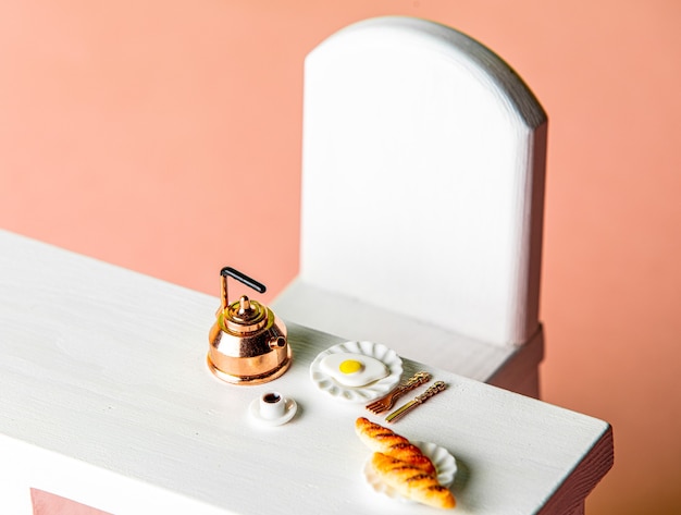 Coffee cup and buns with eggs on a table