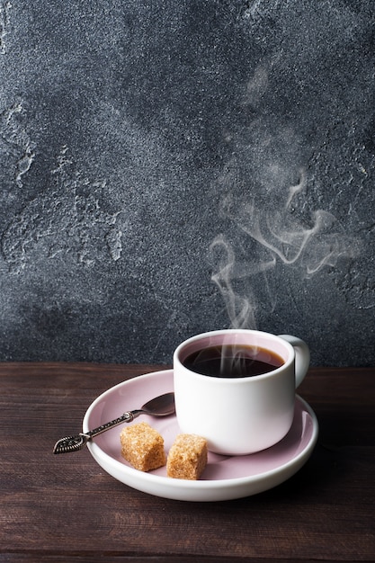 Coffee cup and coffee beans on dark background. copy space