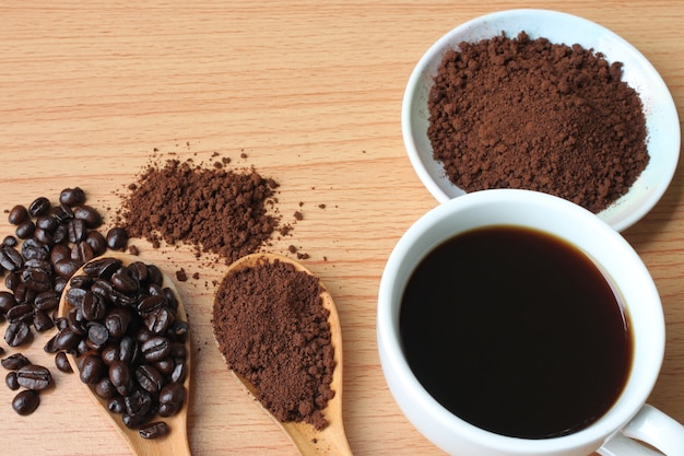 Foto tazza di caffè e chicchi di caffè sul tavolo di legno.