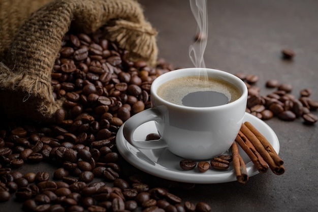 Coffee in a cup on coffee beans