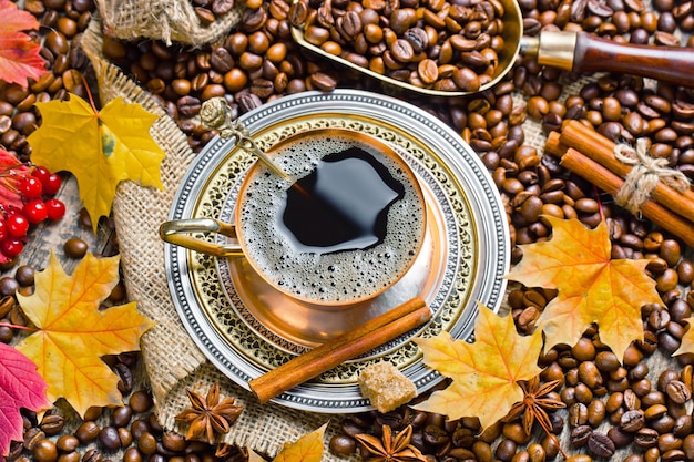 Coffee in a cup on coffee beans