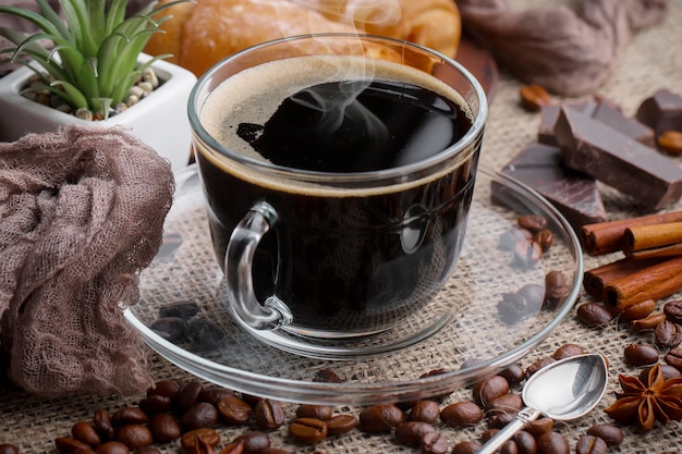 Coffee in a cup on coffee beans