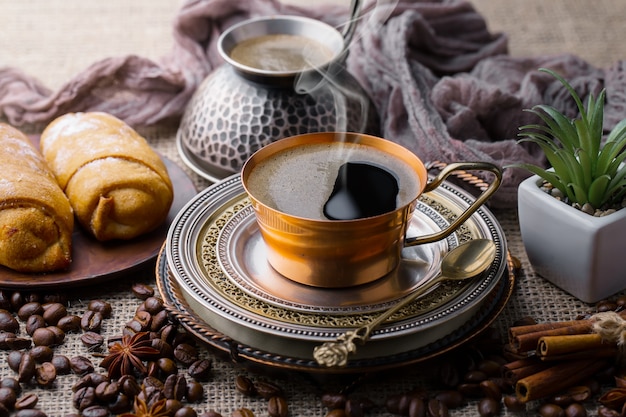 Coffee in a cup on coffee beans