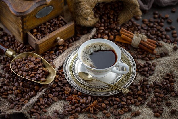 Coffee in a cup on coffee beans