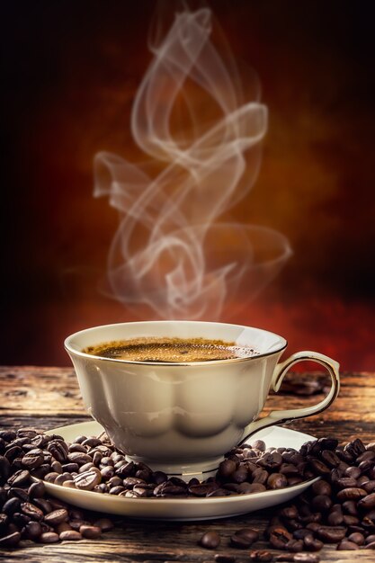 Coffee. Cup of coffee and coffee beans. Vintage cup and old oak table.