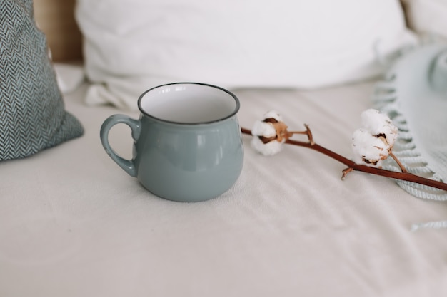 coffee cup and cotton twig breakfast in bed