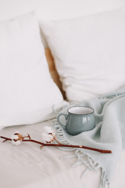 coffee cup and cotton twig breakfast in bed