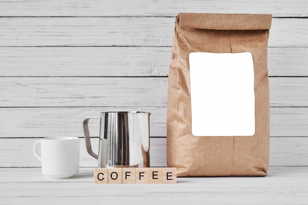 Photo coffee cup, craft paper bag and stainless pitcher