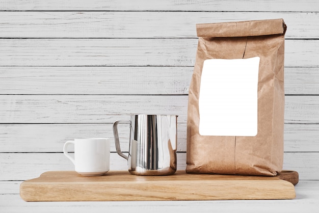 Coffee cup, craft paper bag and stainless pitcher