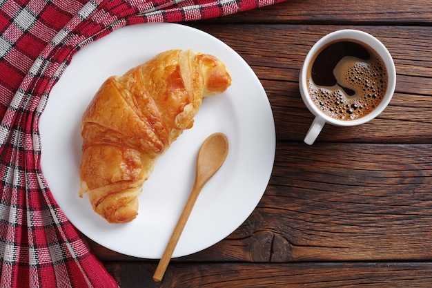 Coffee in cup and croissant