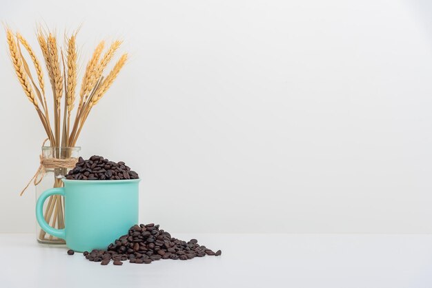 Coffee cup full of coffee beans Realistic coffee beans in green cup isolated on white background