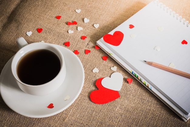 Coffee cup and hearts on sackcloth textures