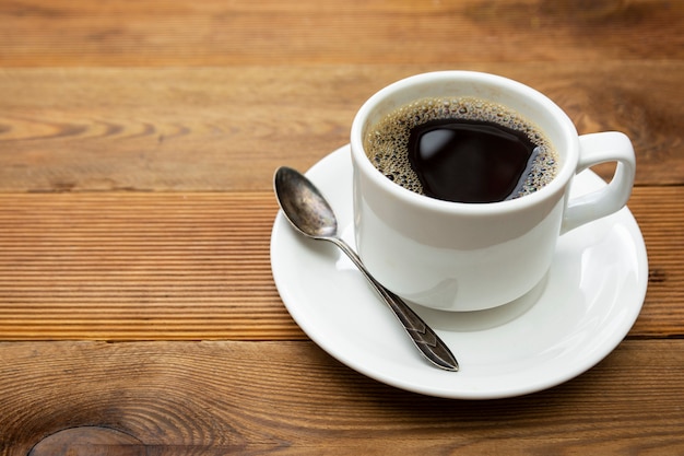 Coffee cup isolated on wooden table. Top view, flat lay coffee drink with copy space.