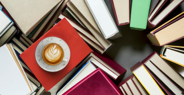 Coffee cup and many books