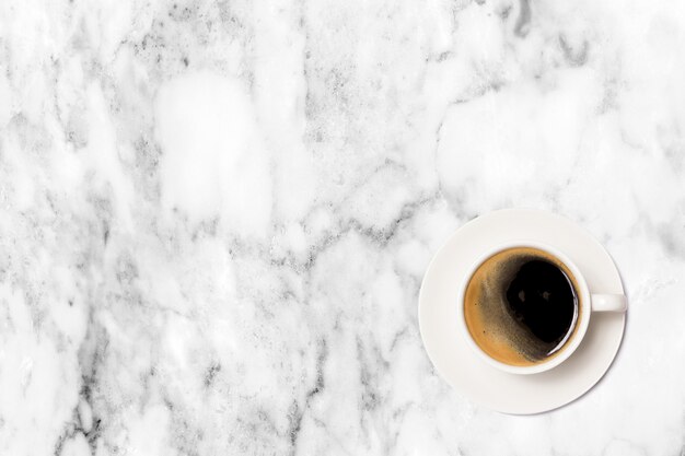 Coffee cup on marble table top view.