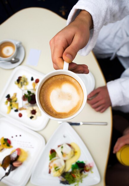 Coffee cup in nahd at table