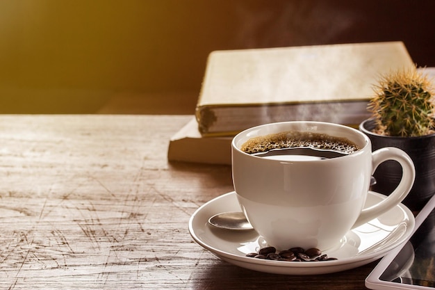 Coffee cup and note book on wooden table