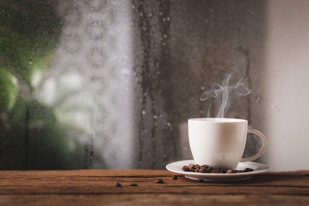 Coffee cup on a rainy day window