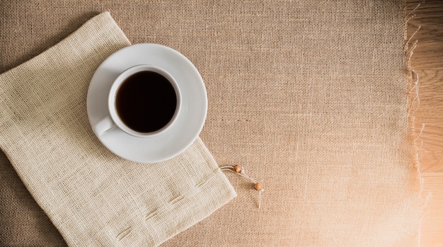 Coffee cup on sackcloth textures