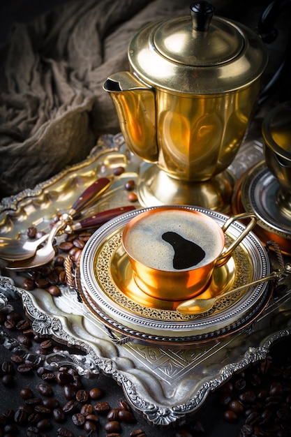 Coffee in a cup and saucer on an old background