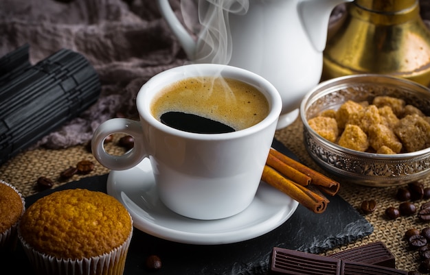 Coffee in a cup and saucer on an old background