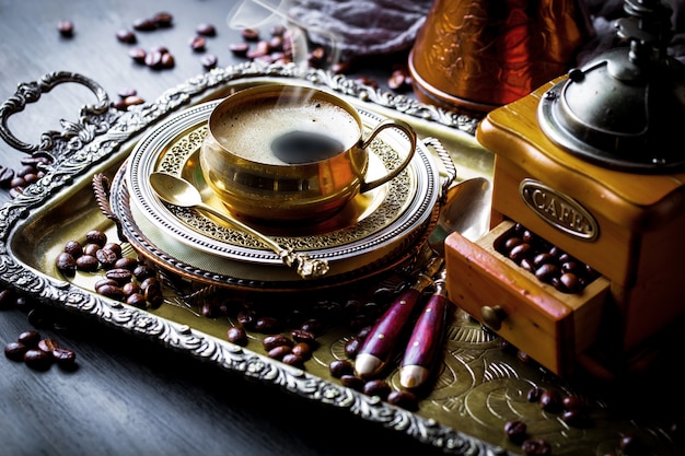 Photo coffee in a cup and saucer on an old background