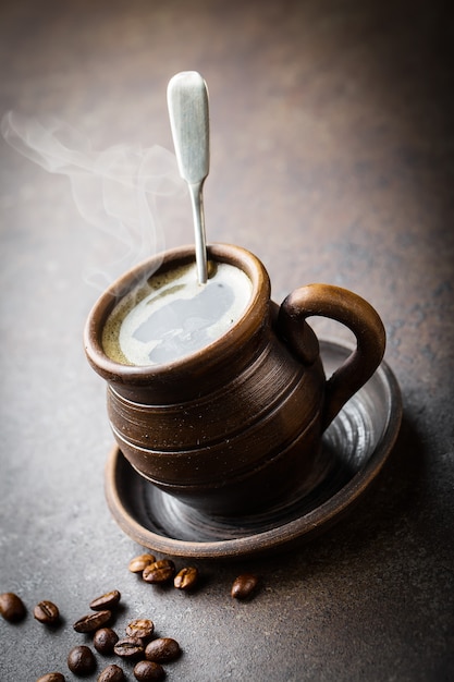 Coffee in a cup and saucer on an old backgroundkground.