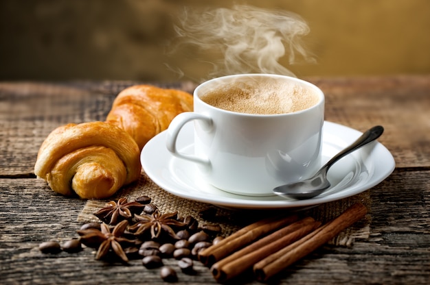 Coffee in a cup and saucer on an old space.