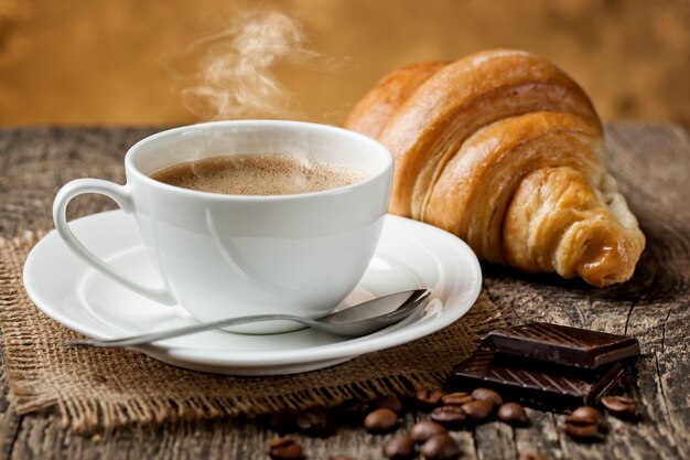 Coffee in a cup and saucer on an old space.