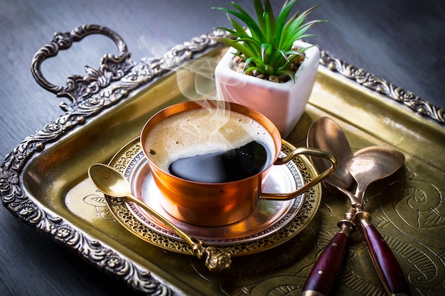 Coffee in a cup and saucer on an old.