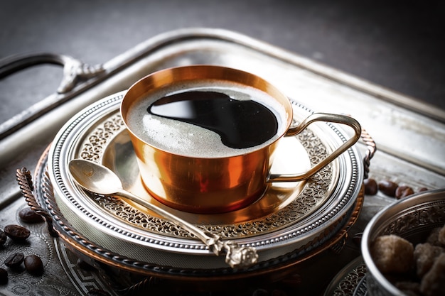 Coffee in a cup and saucer on an old.