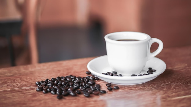 Coffee cup and saucer on a wooden table Dark background