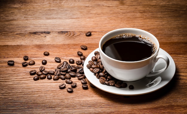 Coffee cup and saucer on a wooden table.