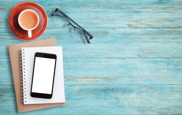 coffee cup and stationary on wood table