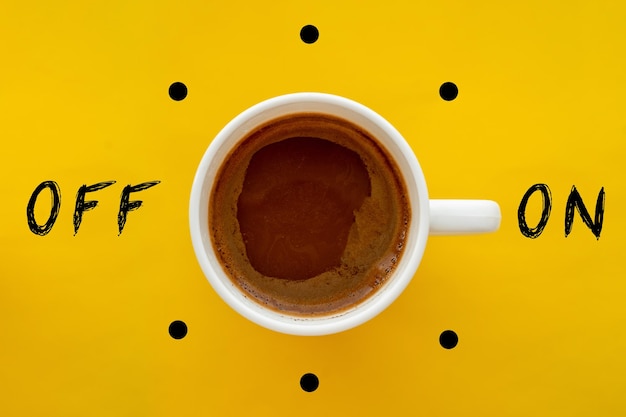 Coffee cup switch on off concept on yellow background Morning wake up coffee break concept