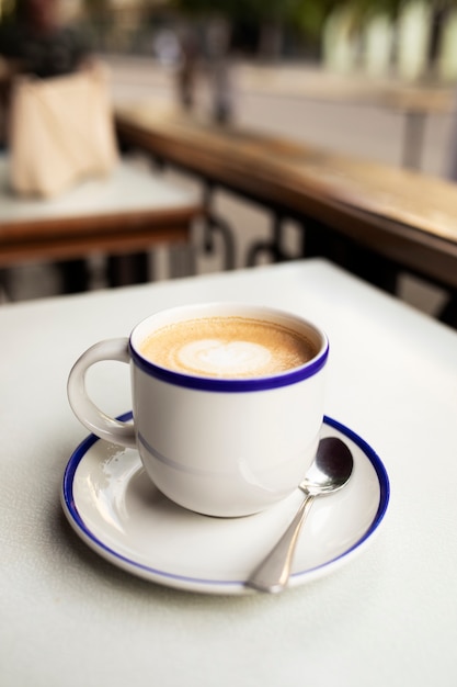 Coffee cup on terrace high angle