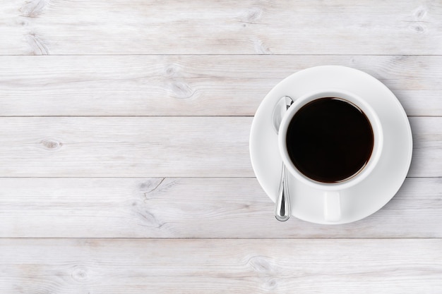 Coffee cup top view on wooden background with copy space