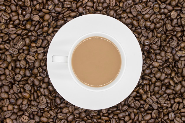 Coffee cup with beans background