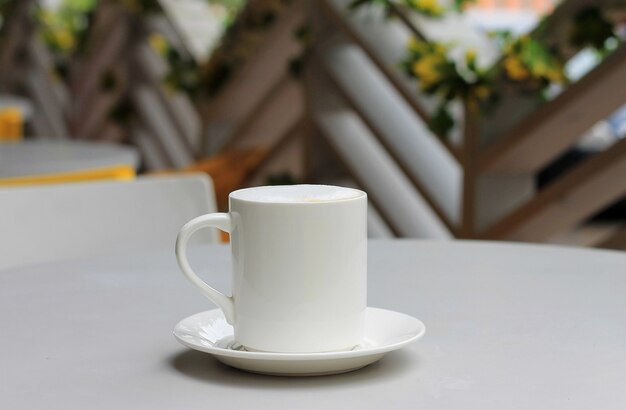 Coffee cup with cappuccino on a table in a cafe