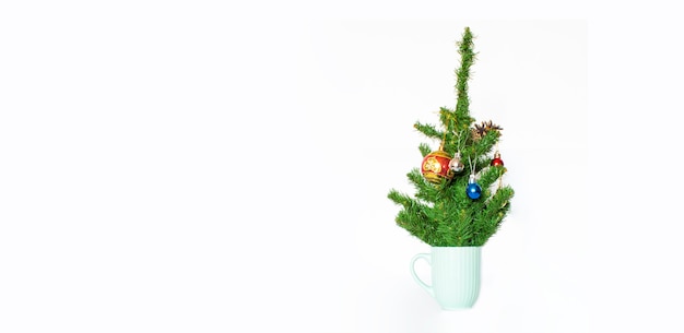 Coffee cup with Christmas tree. Minimal winter holidays concept.