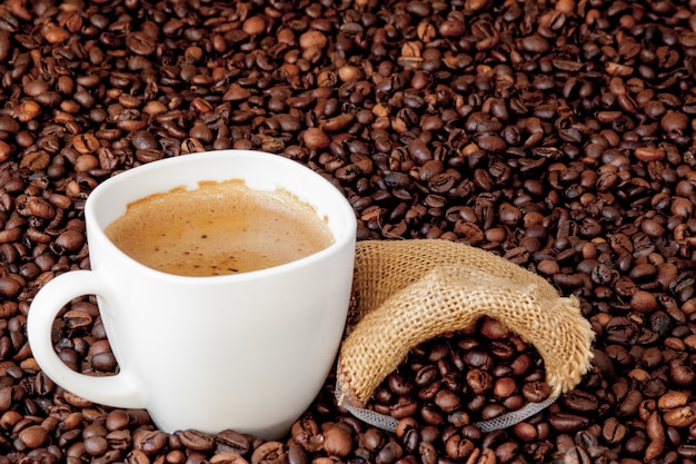 Coffee cup with coffee bag on wooden table. View from top.