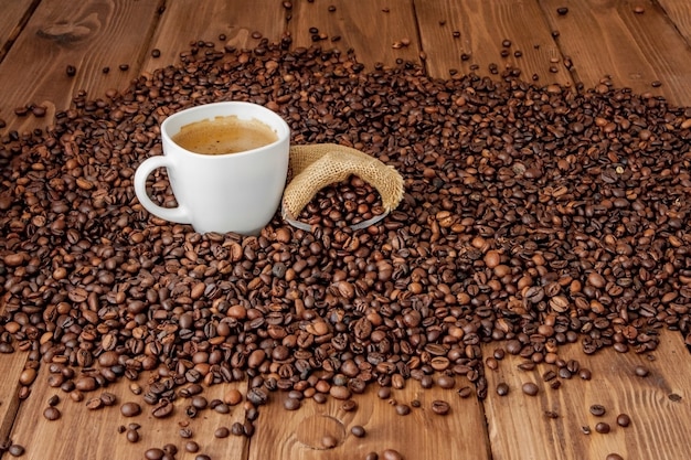 Coffee cup with coffee bag on wooden table. View from top.