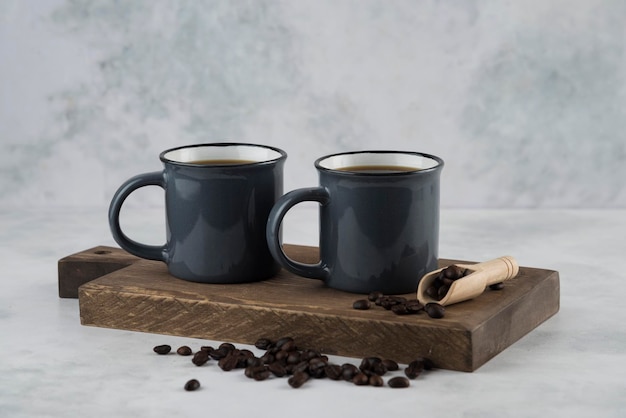 Coffee in cup with coffee beans on cutting wood plate