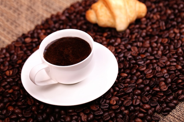 Coffee cup with a croissant 