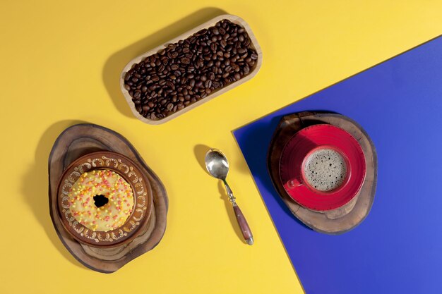 Coffee in a cup with dessert on a bright colored background