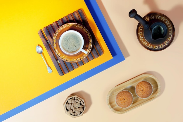 Coffee in a cup with dessert on a bright colored background