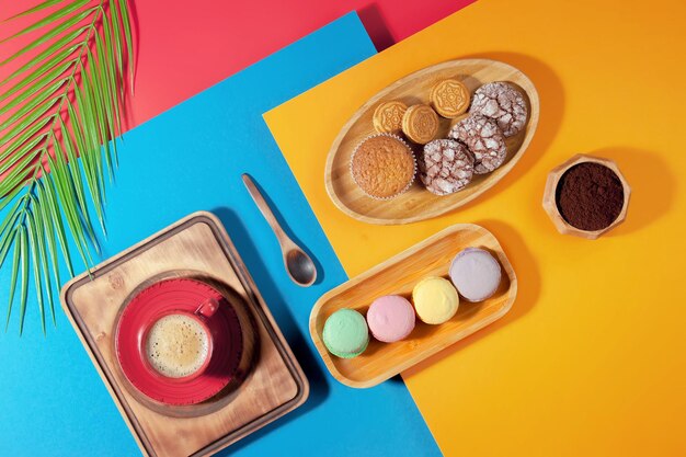 Coffee in a cup with dessert on a bright colored background