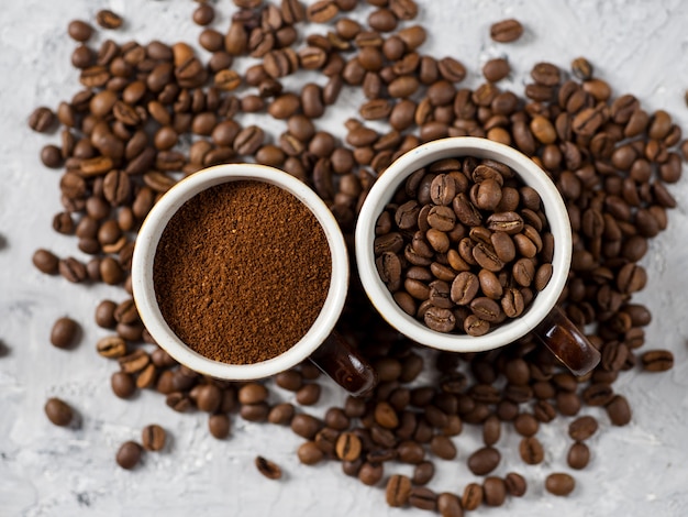 Tazza di caffè con caffè appena macinato e chicchi di caffè naturali